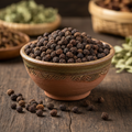 Uziza seeds in ceramic bowl on wooden surface