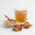 Organic Baobab Tea in a glass mug with dried baobab fruit and powder