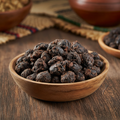 Dawadawa fermented locust beans in wooden bowl